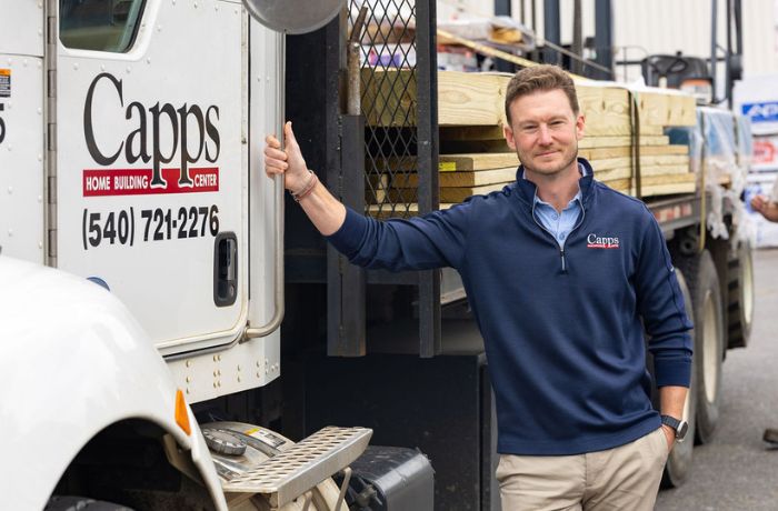 Contractor Sales representative standing in front of a delivery truck